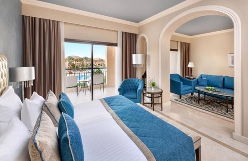 Village Road Resort | Bright & Airy Junior Suite – Lounge, Dressing Room, and Sparkling Pool Views
