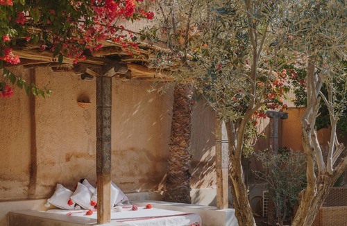 Oumnass House | Pool-view romantic bedroom