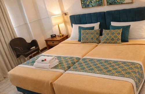 Luxor Hotel | Twin Room with King Bed Setup, Wi-Fi, AC & Private Bathroom