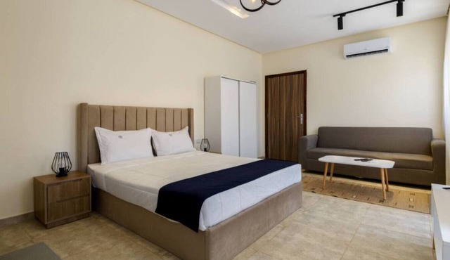 Comfy Studio with Balcony | Queen Bed , Sofa and Kitchenette and shared community garden